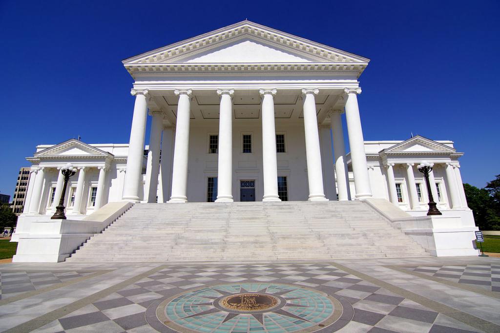 Virginia State Capitol with grand columns and wide stone steps under clear blue sky